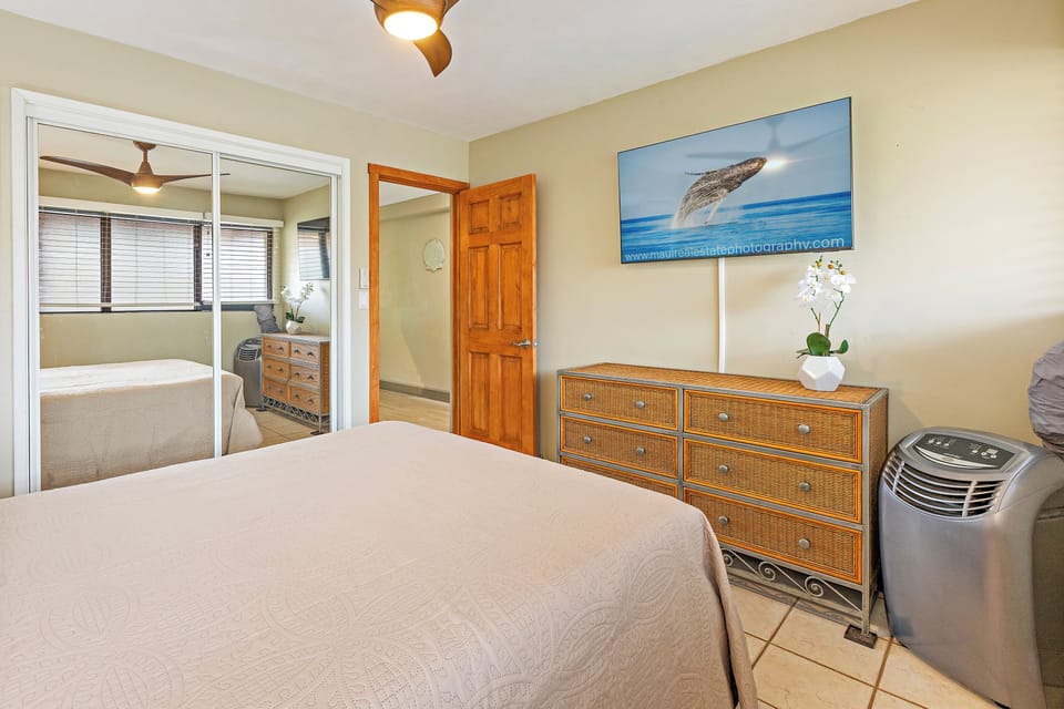 Relax in style in this charming bedroom designed with comfort and tropical elegance.