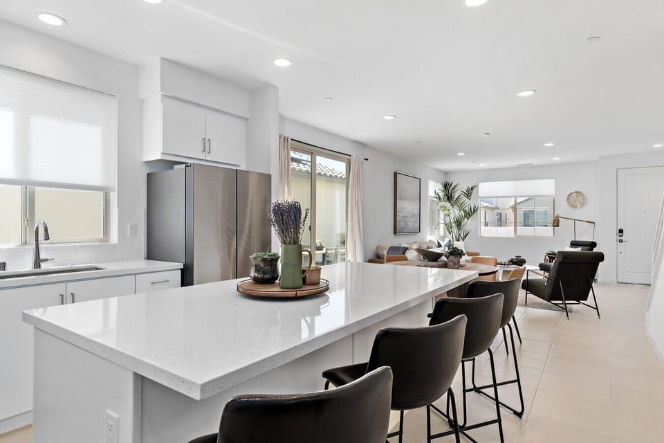 Modern kitchen w/ large island seating & sleek stainless appliances