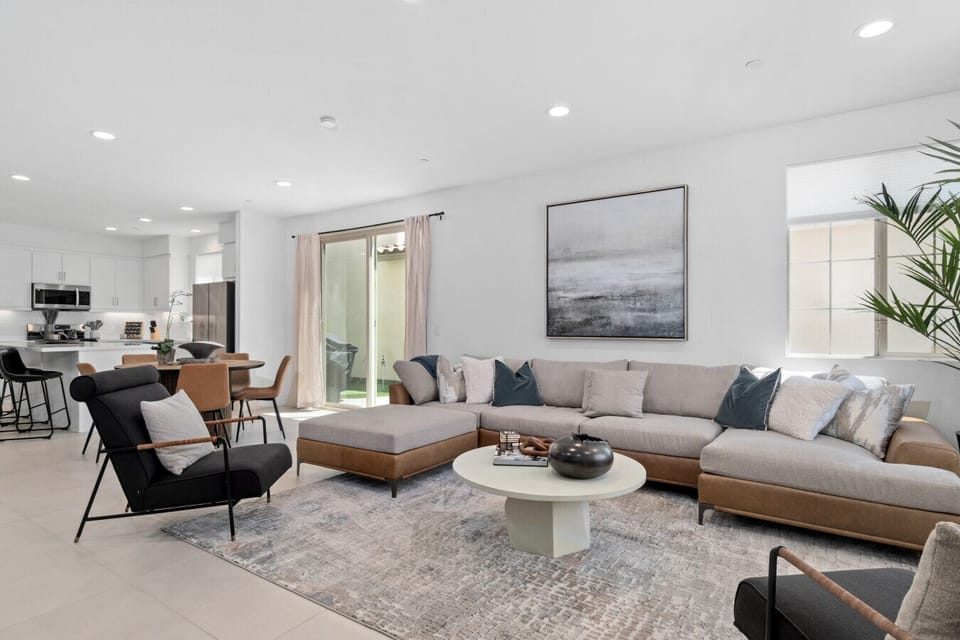 Bright living room w/ cozy sectional, armchairs & natural light throughout