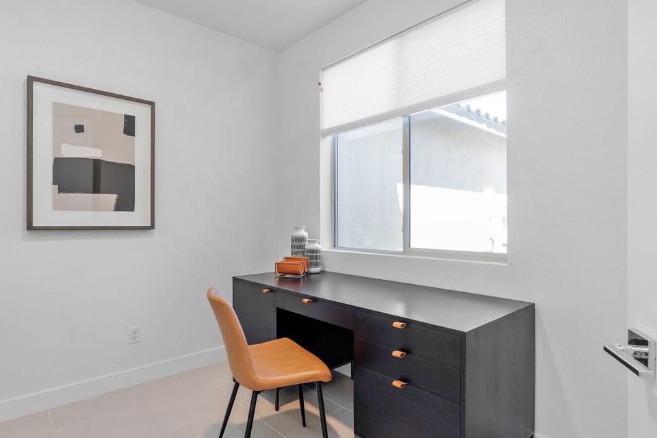 Bright workspace w/ desk, chair & window light, ideal for focused remote work