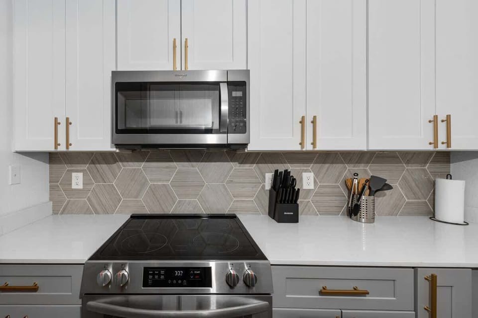 Functional kitchen with oven, stove, fridge and basic cooking ware