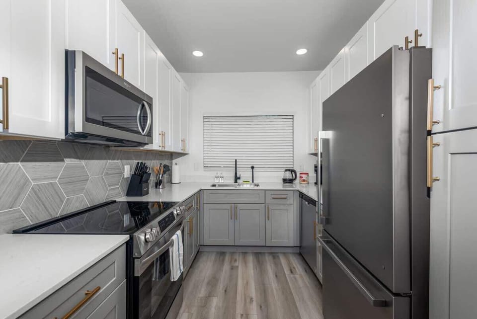 Functional kitchen with oven, stove, fridge and basic cooking ware