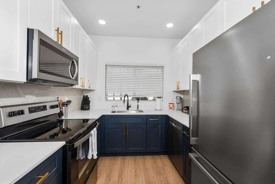 Functional kitchen with oven, stove, fridge and basic cooking ware