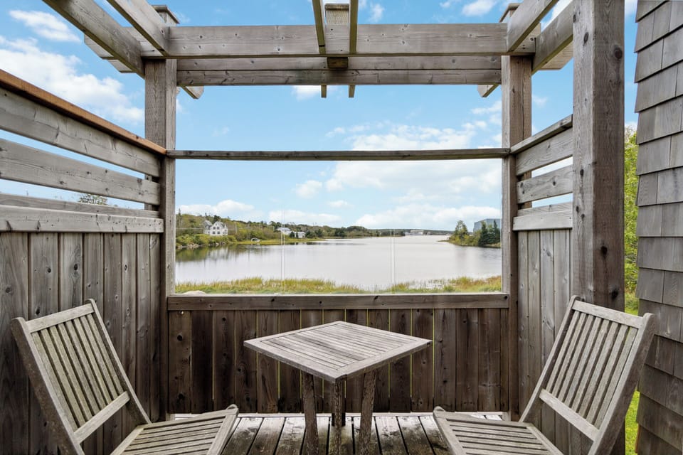 Cozy private deck with stunning waterfront views, perfect for relaxing outdoors.