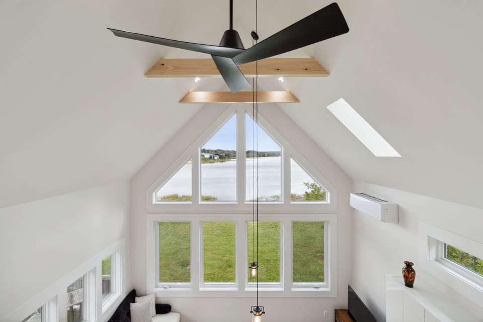 Vaulted ceilings, modern lighting, and stunning waterfront views from the loft.