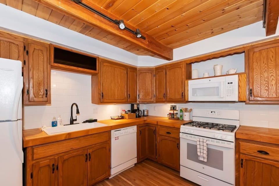 The kitchen in the cabin comes with all of the necessary supplies to make a delicious meal.