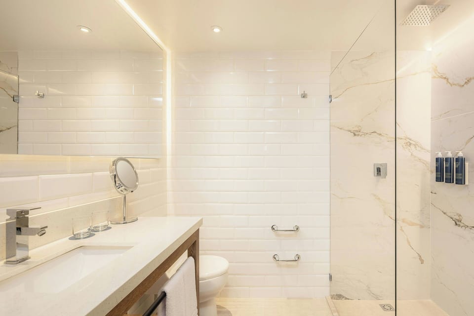 Shower, rainfall showerhead, hair dryer, towels