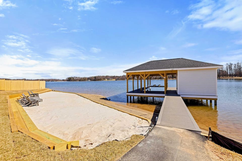 Private Beach and Dock: Enjoy serene lakeside relaxation on your own private sandy beach, complete with comfortable seating and direct dock access for boating and water activities.