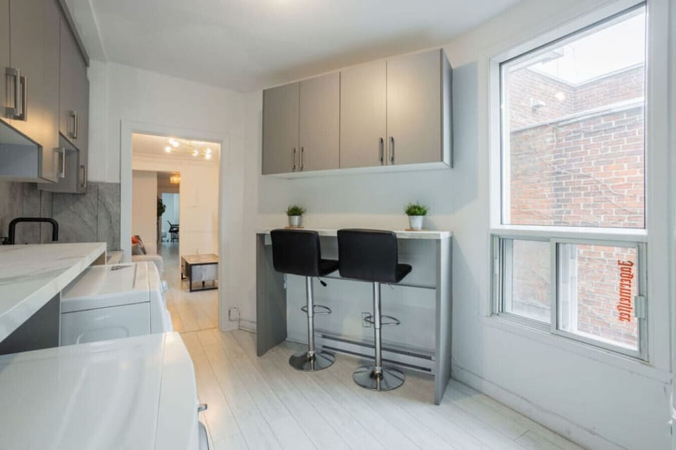 Start your morning right at this cozy breakfast bar, bathed in natural light from large windows that offer a charming street view