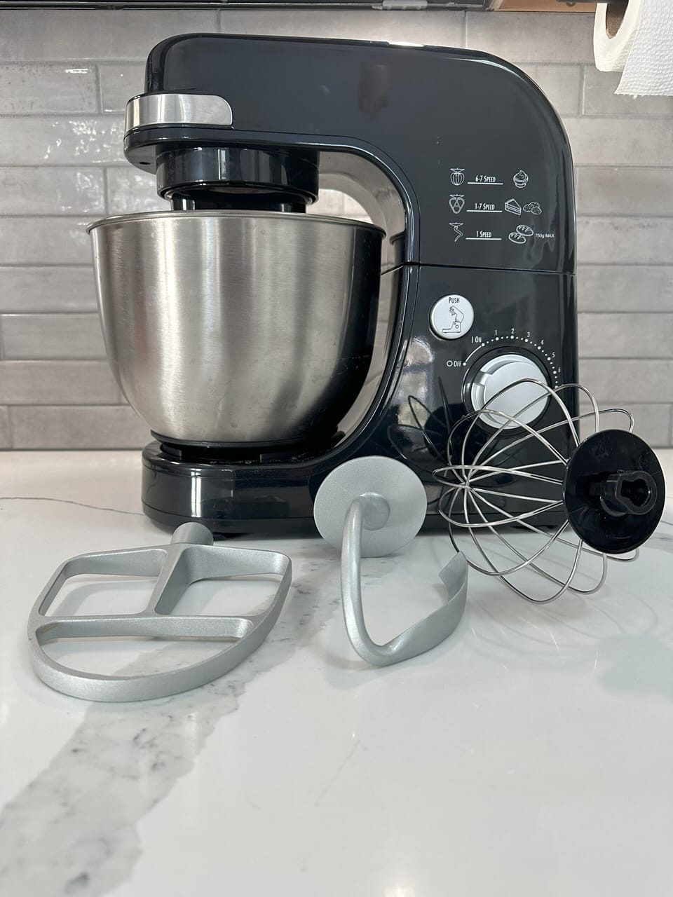 Stand mixer with attachments.  Under the kitchen island.