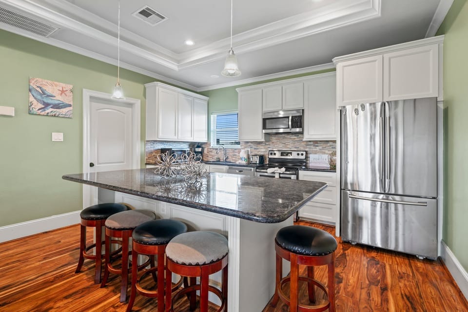 Large kitchen island counter with outlets for charging your devices.