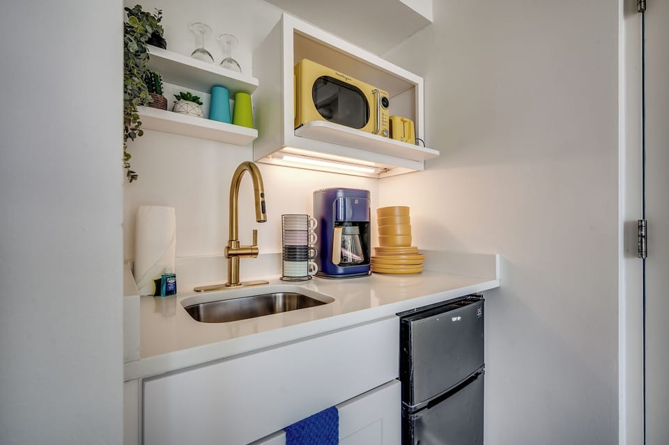 A kitchenette with bold pops of color—perfect for your morning coffee!