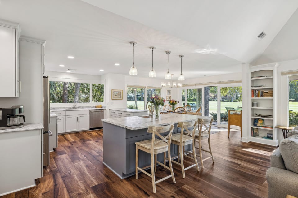Spacious kitchen with stainless steel appliances and 4 barstools.