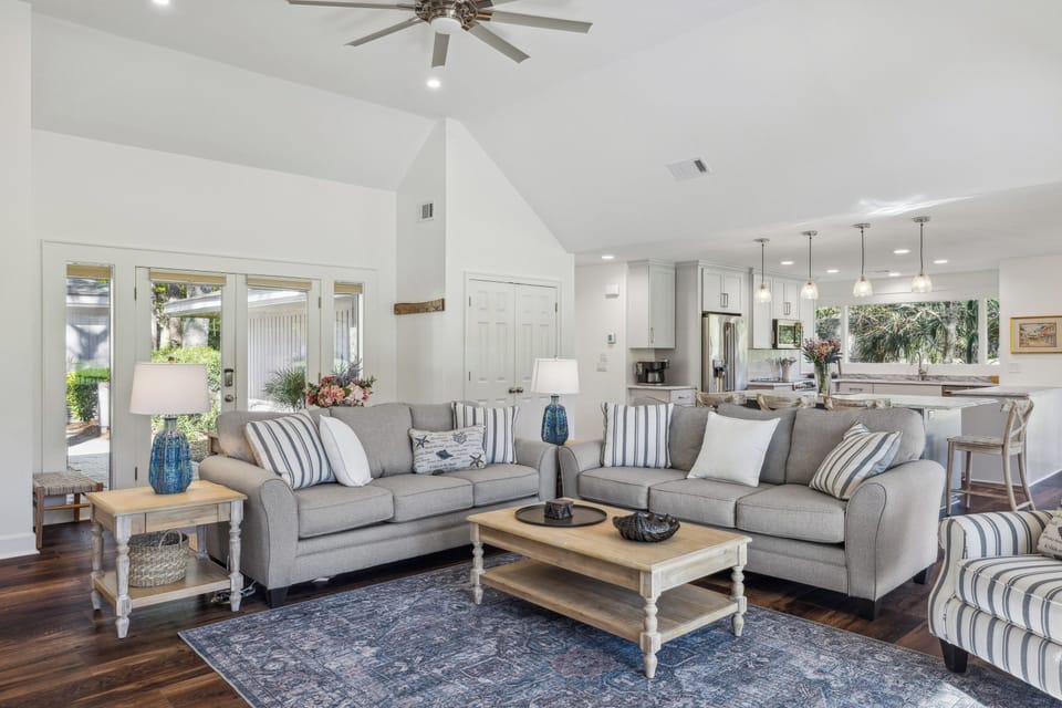 Spacious living room with beautiful golf course views and a flatscreen tv.