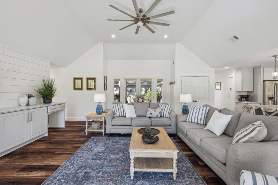 Spacious living room with beautiful golf course views and a flatscreen tv.