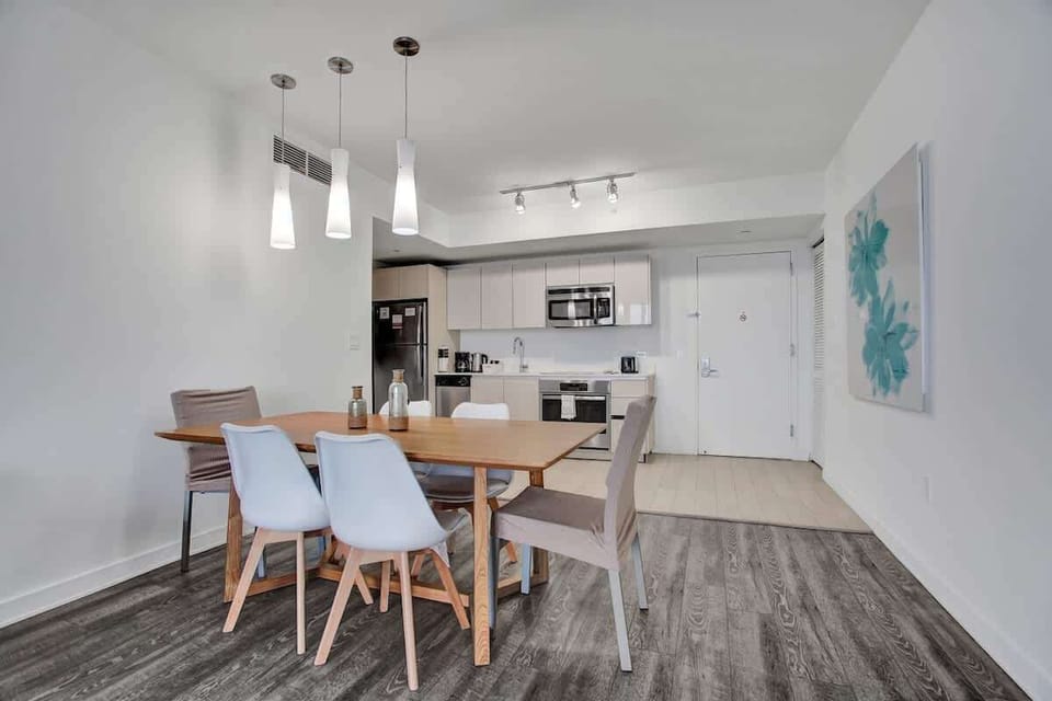 Open space dining area and a fully equipped kitchen with stainless steel appliances to enjoy meals with friends and family