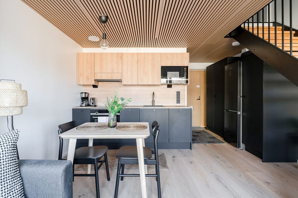 The kitchen is thoughtfully integrated next to the dining area and comes fully equipped with complimentary coffee and tea to start your mornings right. High-speed Wi-Fi covers the entire space, making the dining table a comfortable spot for remote work if