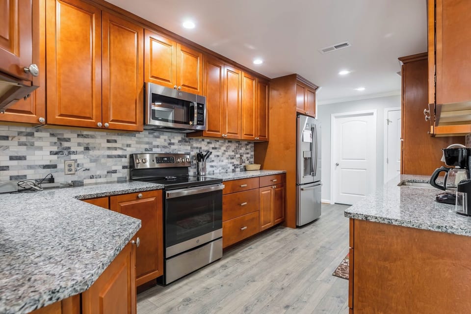 Spacious and fully equipped with sleek granite countertops and modern appliances.