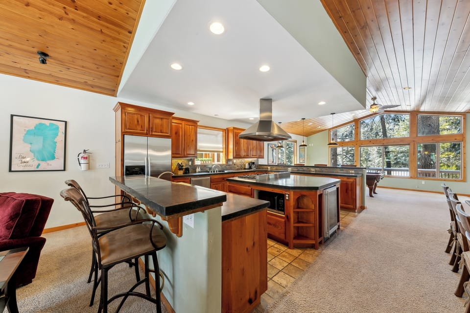 Your spacious kitchen flows seamlessly into the dining area, where rich wood cabinets and granite counters create the perfect space for cooking together.