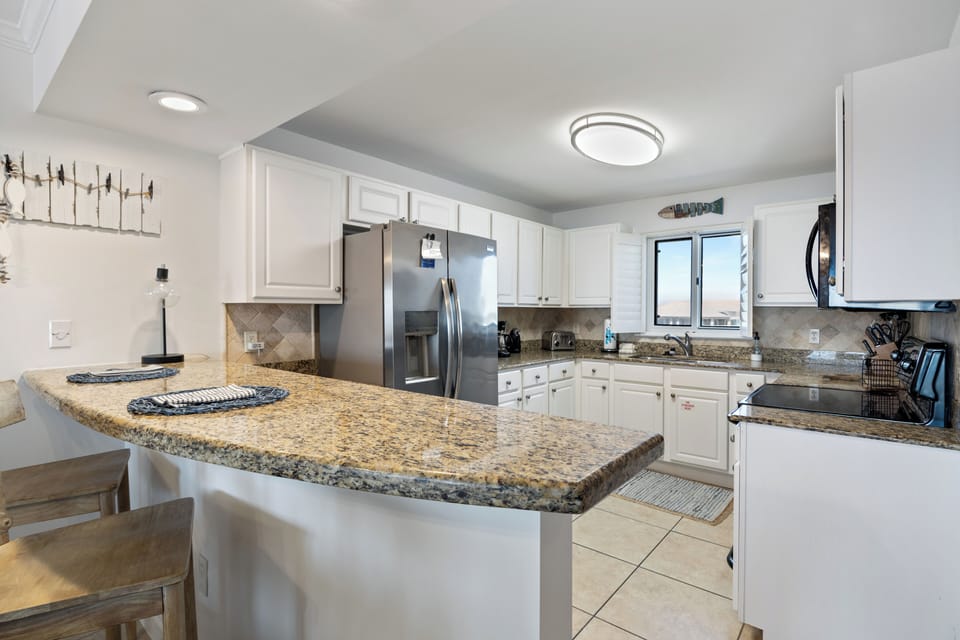 Sandy Key Unit 513 by PKRM - Modern kitchen is fully equipped.