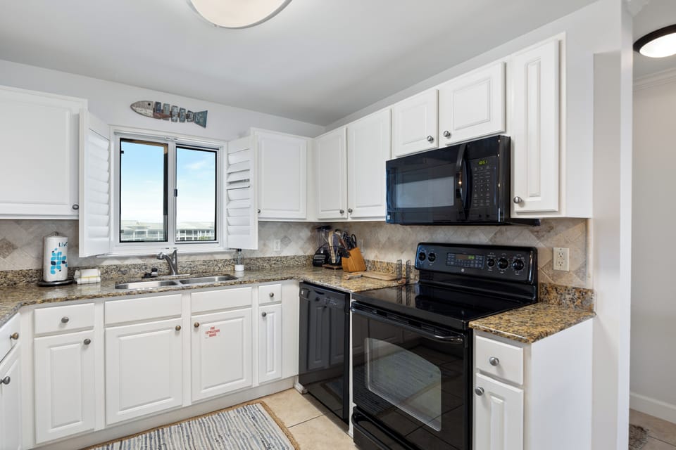 Sandy Key Unit 513 by PKRM - The view out the kitchen window is of the pickleball / tennis courts!