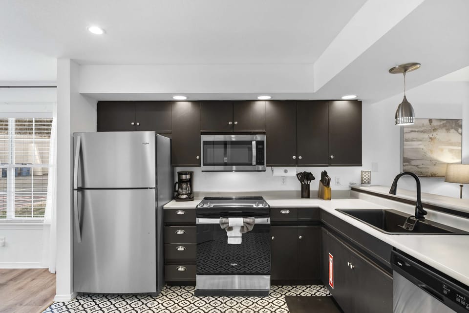 The sleek, open kitchen offers ample space & every home comfort