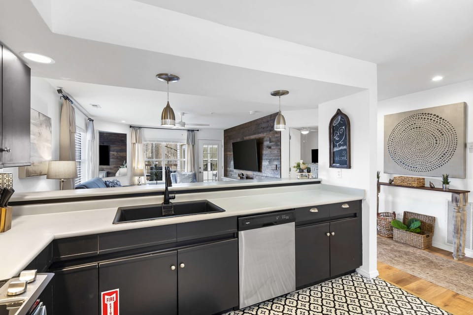 The sleek, open kitchen offers ample space & every home comfort