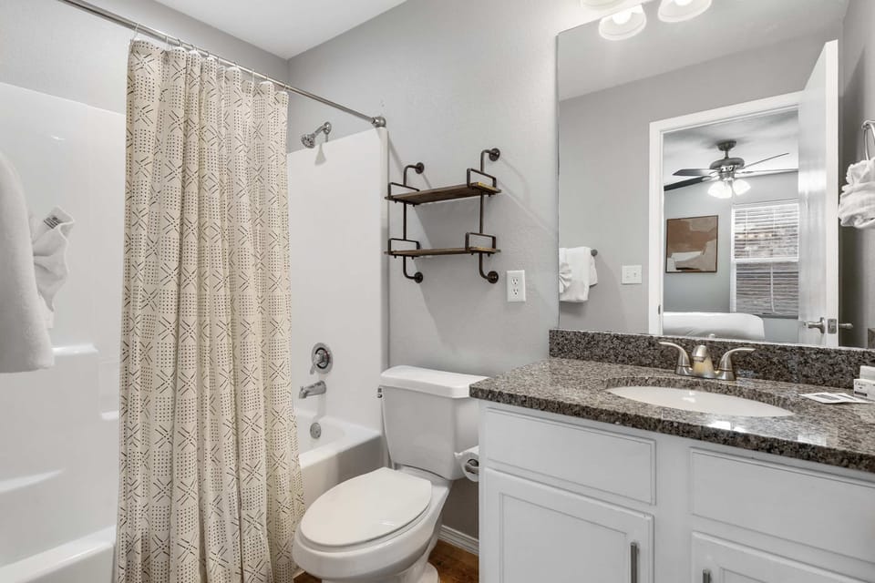 A single vanity & shower/tub combo await in the king ensuite
