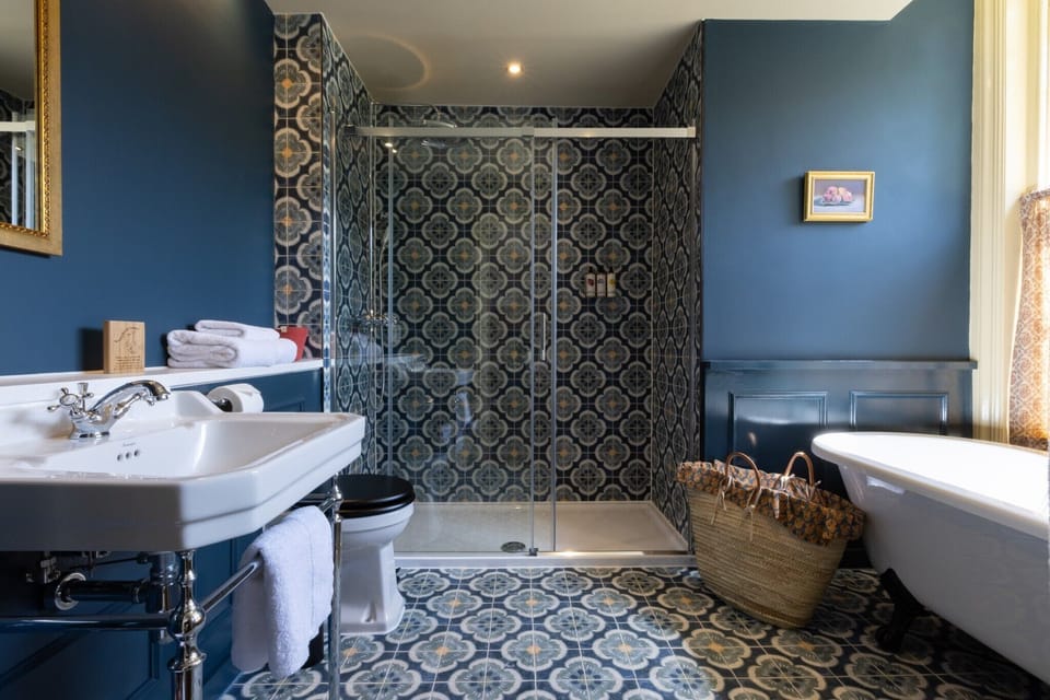 Really Fancy Family Room | Bathroom | Designer toiletries, hair dryer, towels, toilet paper