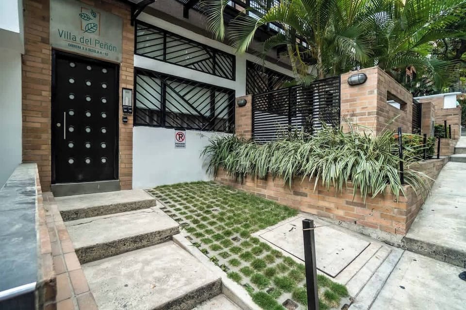The access to the apartment is through this door on the left and up the stairs. 