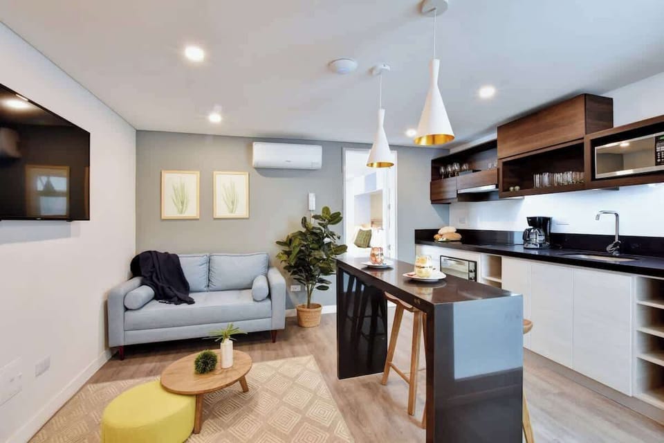 The living room / kitchen area with SmarTV and A/C. 