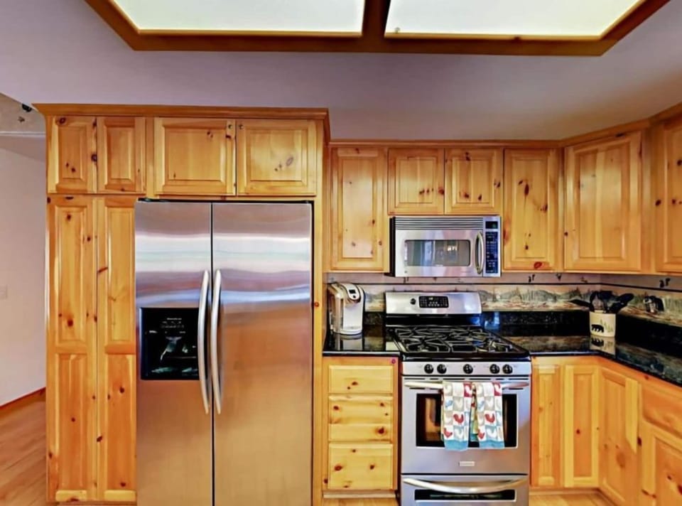 Cook in style with our modern kitchen featuring wooden cabinetry and stainless steel appliances