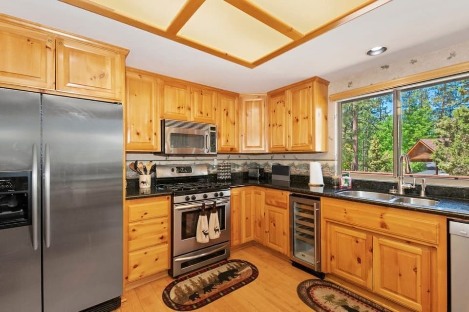 Cook in style with our modern kitchen featuring wooden cabinetry and stainless steel appliances