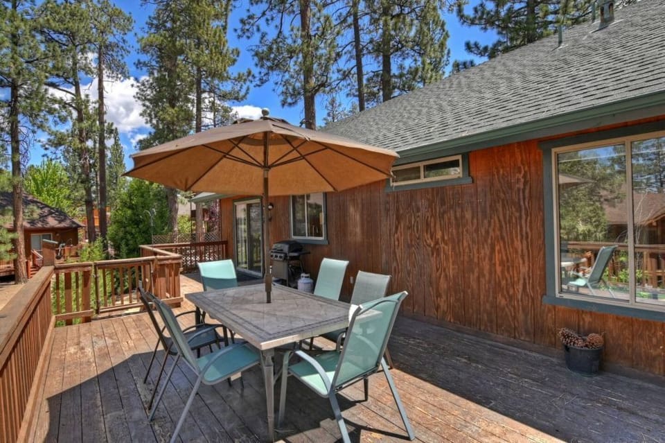 Dine alfresco on our wooden deck, surrounded by tall pines