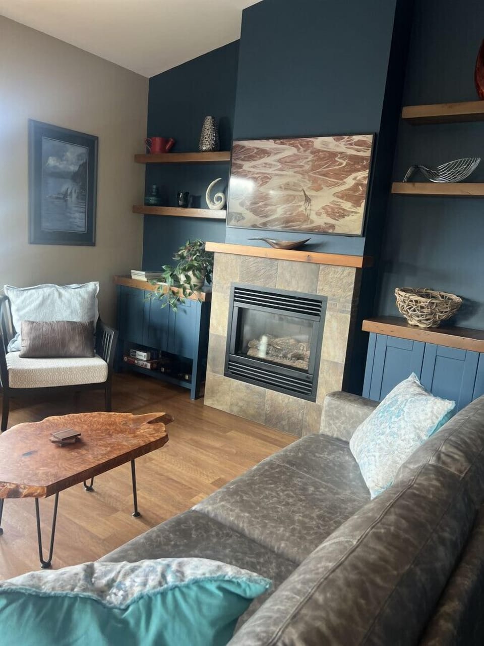 Living room with custom built cabinets and coffee table from refurbished cedar.  Lay back and enjoy the views!