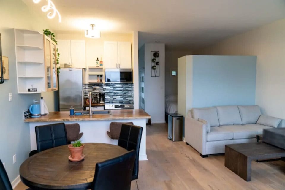 Main entertainment area with living room, kitchen and dining in open room concept.