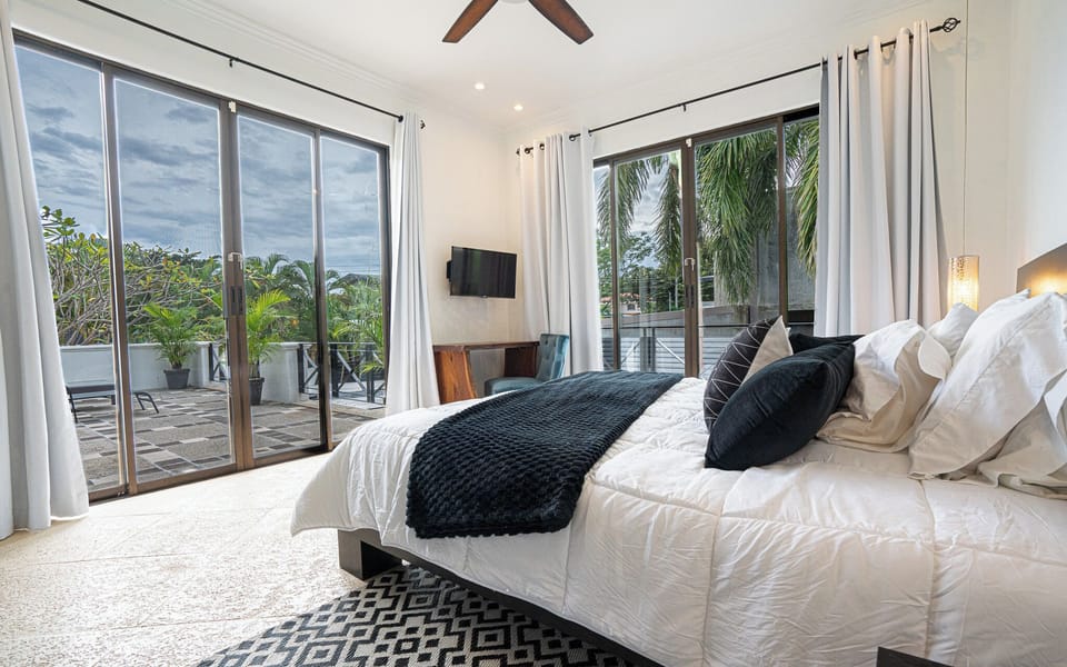 Upstairs bedroom with sliding glass doors leading to the outdoor balcony 