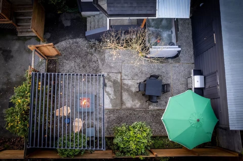 Overhead view of the patio with a fire pit, hot tub, and grill.