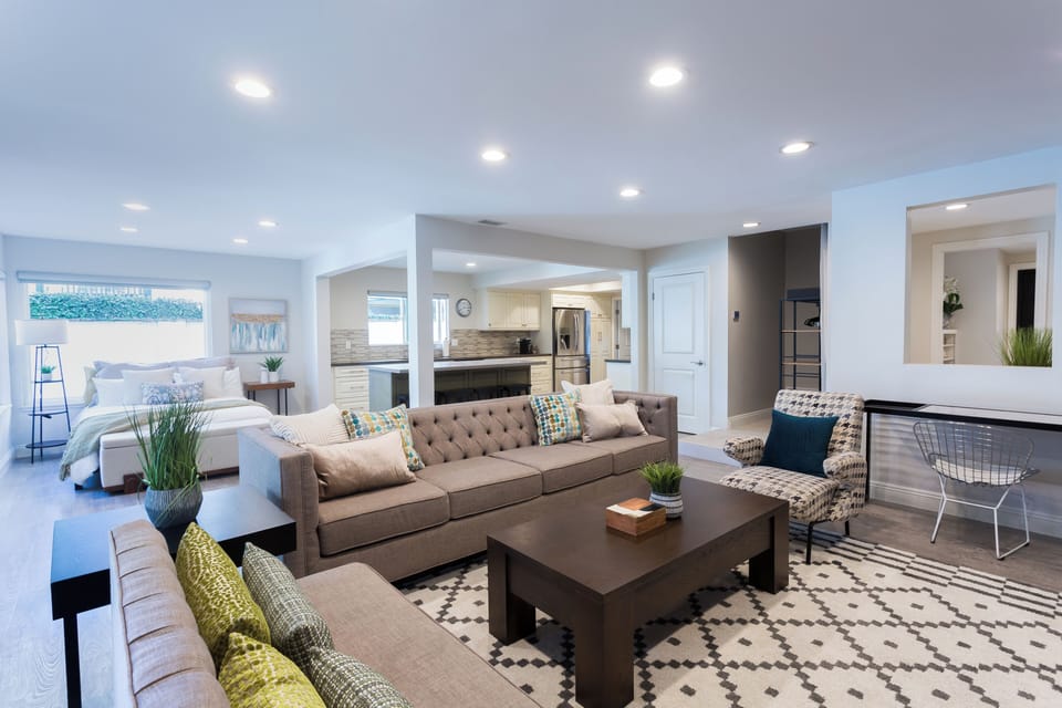 The living room area also has a working desk and printer. 