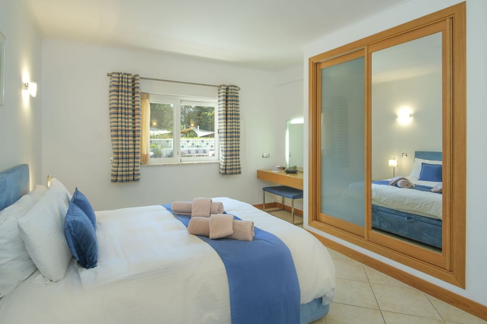 Modern double bedroom with storage and air conditioning