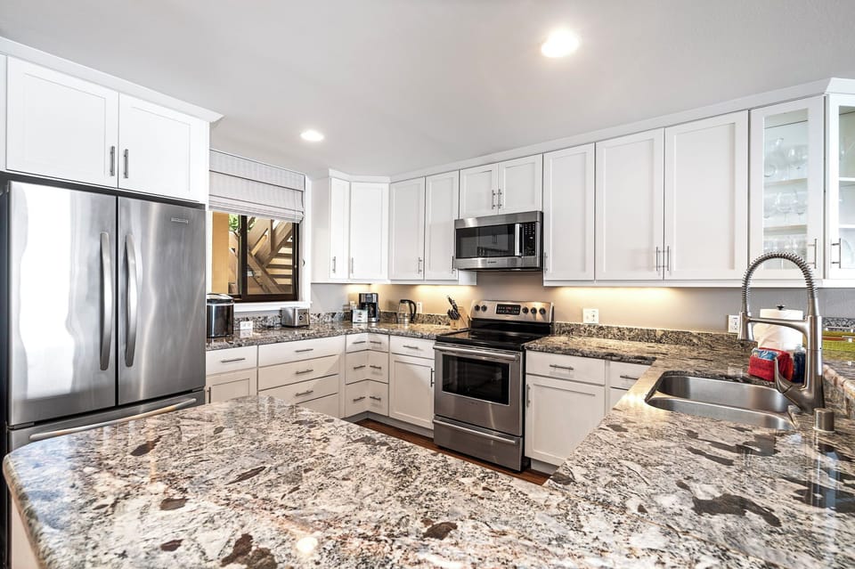 Well-stocked with stainless steel appliances, granite countertops, and a wine fridge