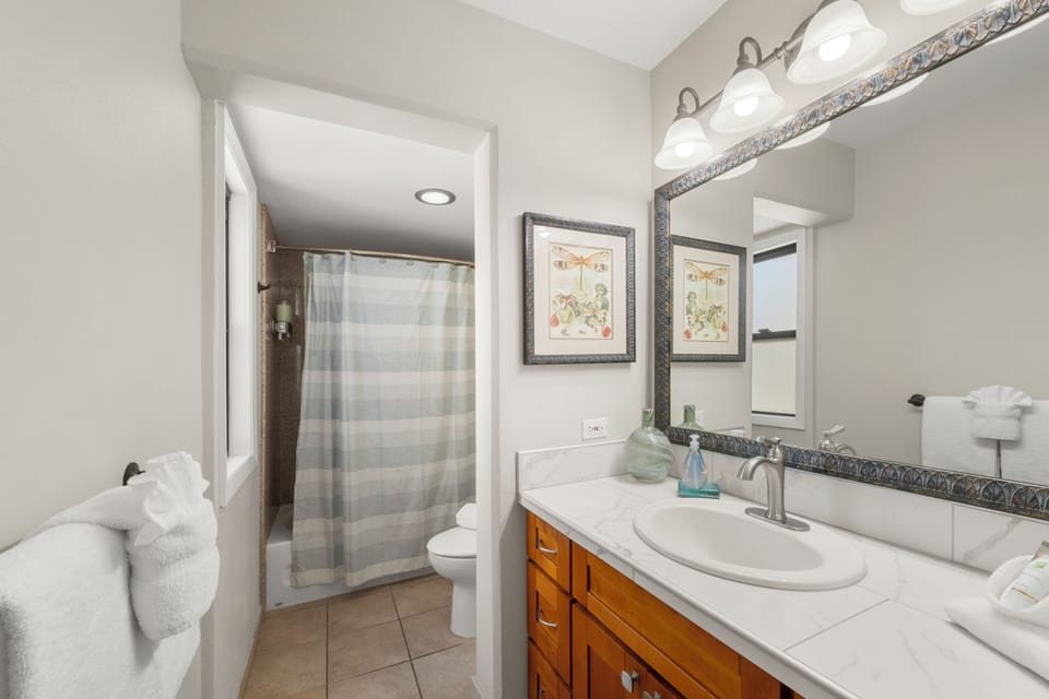 Unwind after a day of island adventures in the tub-shower combo—ideal for a relaxing soak or a refreshing rinse.