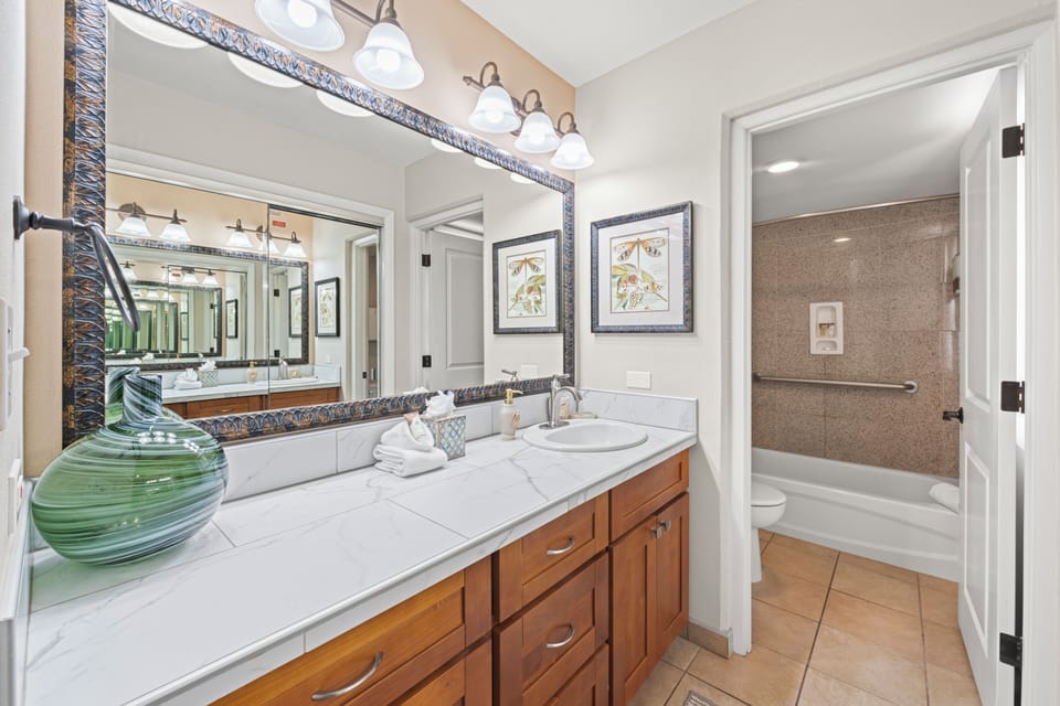 This spacious bathroom features an extended countertop, offering plenty of room for your essentials.