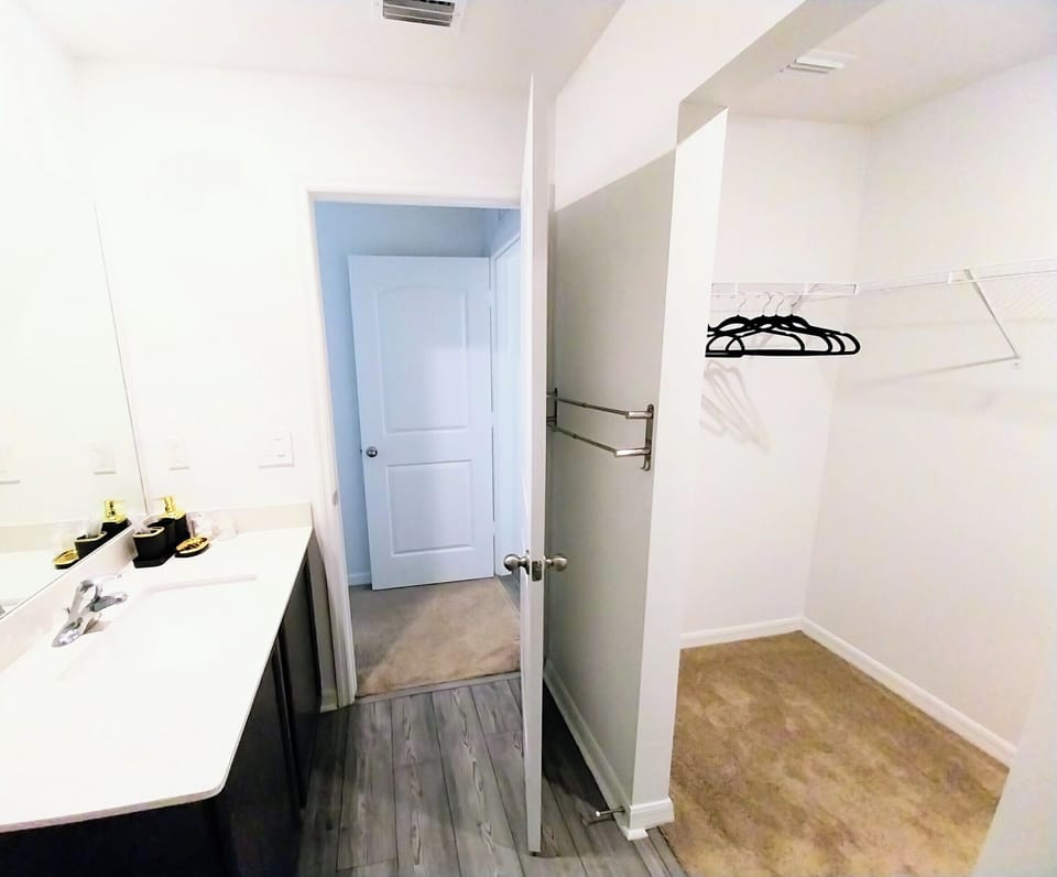 Private bathroom in master bedroom, bathroom amenities, shower, & walk-in closet