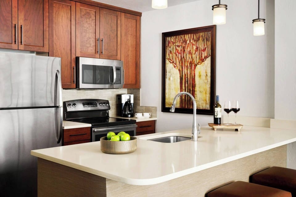 Full kitchen with an oven, stove, microwave, dishwasher, refrigerator, and coffee maker.