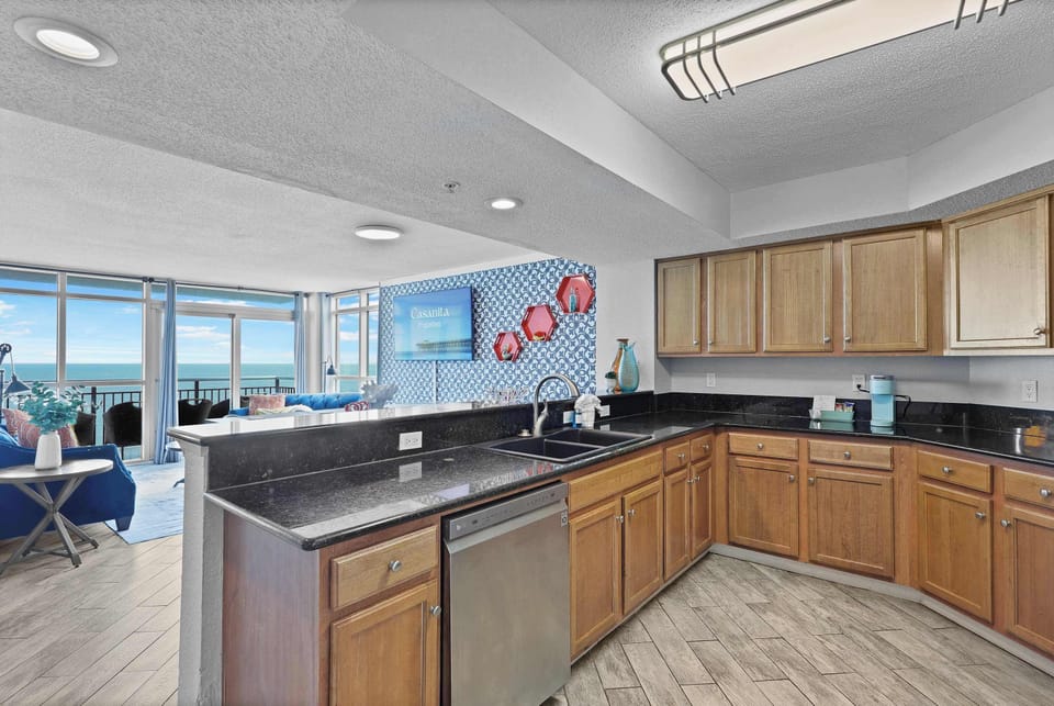 Cook with a view in this spacious, fully equipped kitchen featuring granite countertops, modern appliances, and stunning ocean views. Perfect for whipping up meals while enjoying your Myrtle Beach beachfront escape!