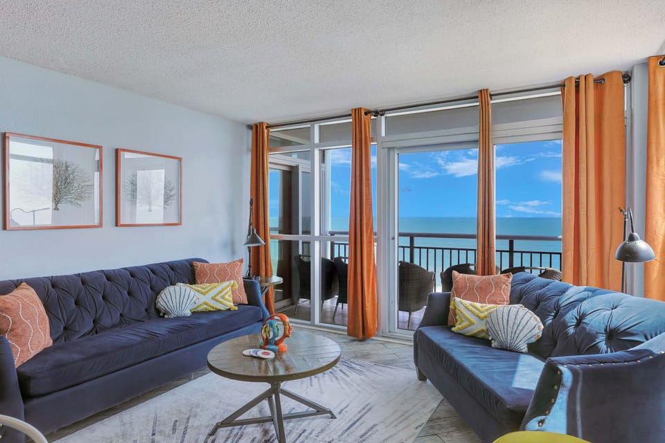 Bright, beachy, and made for memories—soak up stunning ocean views from this one-of-a-kind designer living space just steps from the sand!