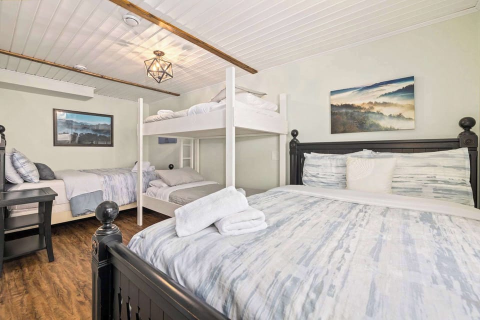 Our fifth bedroom is also downstairs and has a Queen bed and two Twin bunk beds and a nearby shared bathroom.