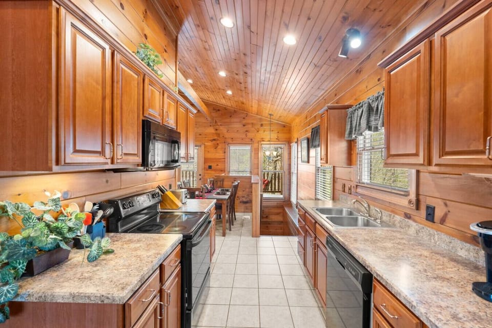 Enjoy the warm, open layout as the kitchen flows seamlessly into the dining area—ideal for connecting over meals or planning your next Smoky Mountain adventure.