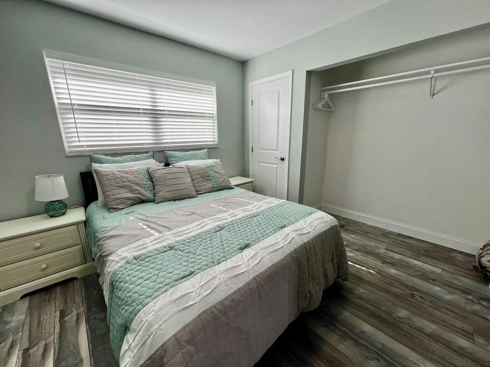 Bedroom closet with space for clothing and luggage.